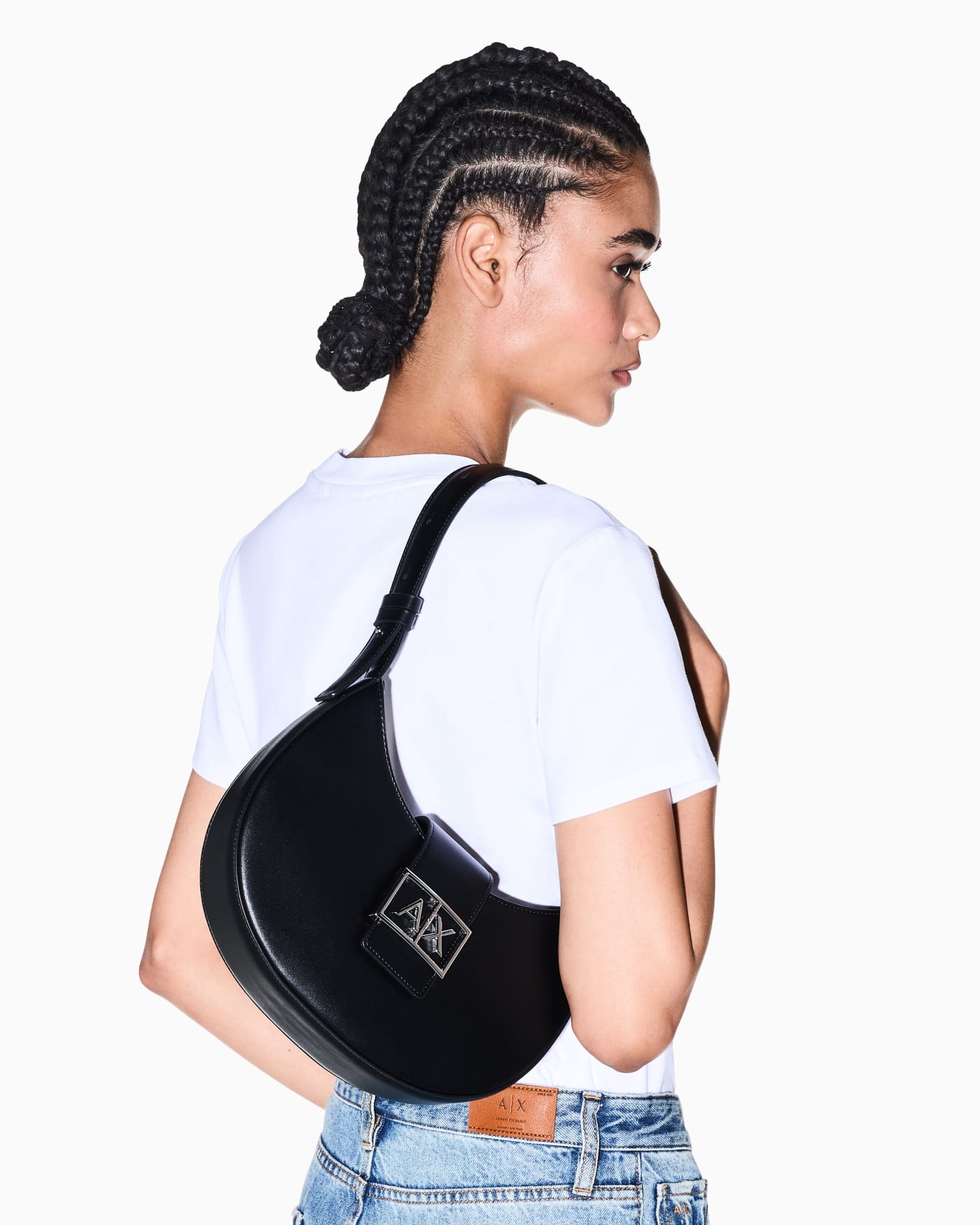 Crescent shoulder bag with a front flap and logo buckle