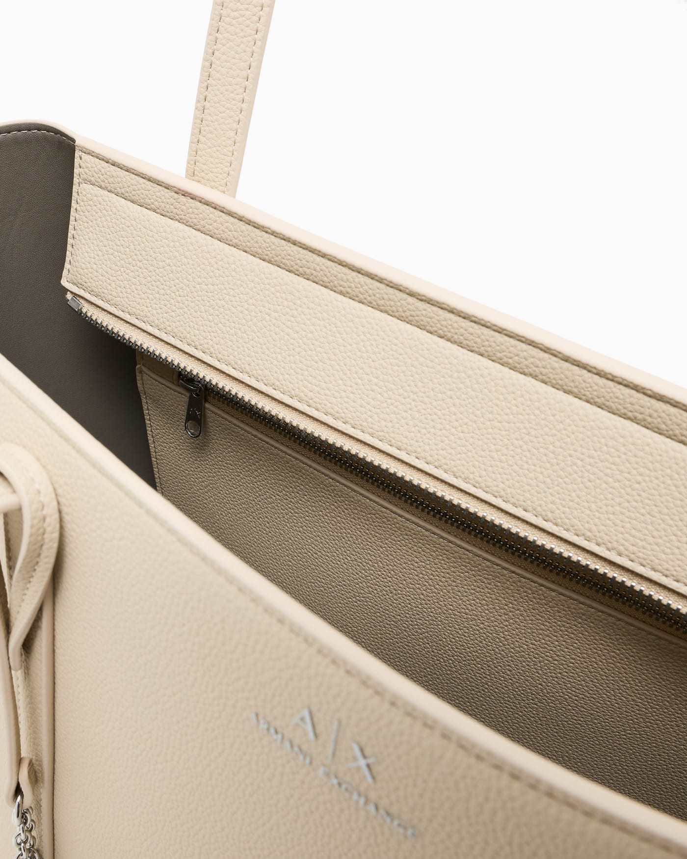 Textured tote bag with handles and a decorative charm