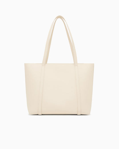 Textured tote bag with handles and a decorative charm