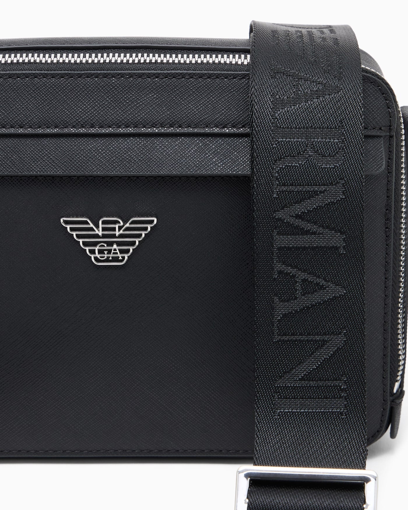 Textured crossbody bag with a front pocket and a metal logo