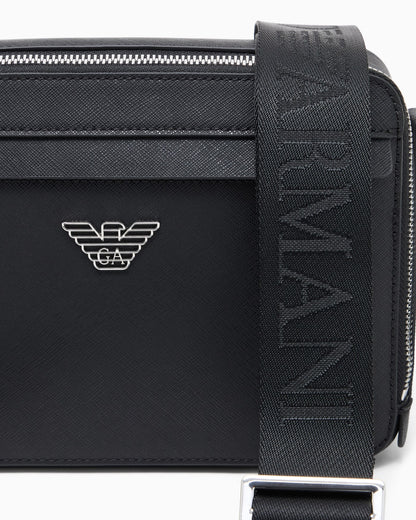 Textured crossbody bag with a front pocket and a metal logo