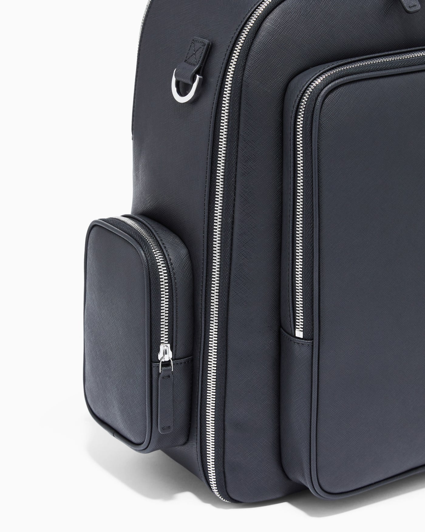 Backpack with a metallic logo and silver-tone zips