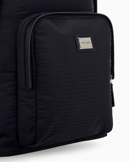 Backpack with a front zip pocket and a metal logo plaque