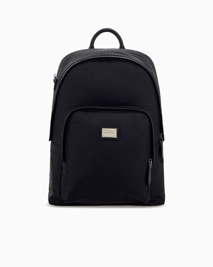 Backpack with a front zip pocket and a metal logo plaque