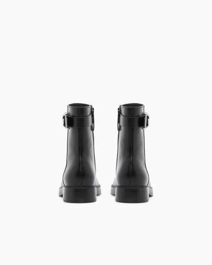 Leather ankle boots with side zip and buckled strap