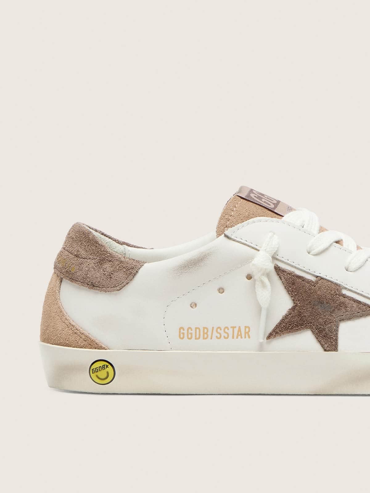 Junior Super-Star in white leather with dark gray suede star and beige suede inserts