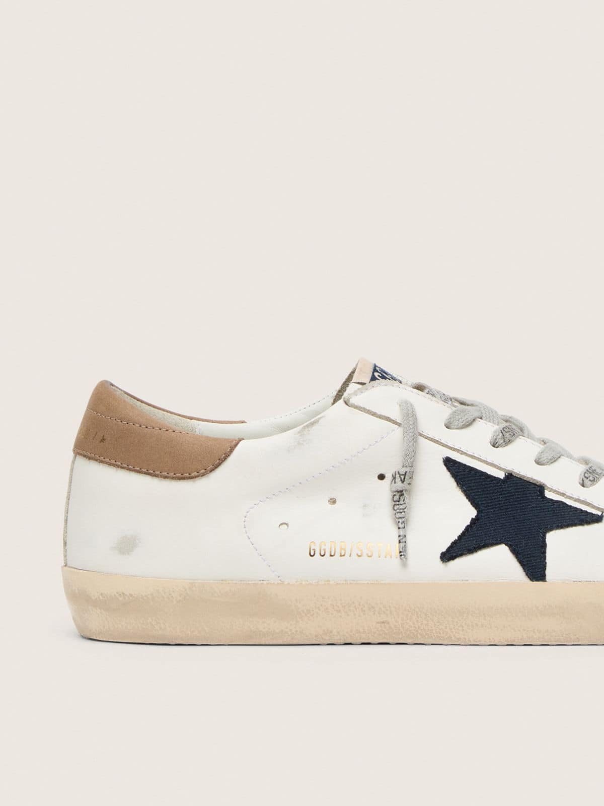 Men's Super-Star in white leather with midnight-blue canvas star and tobacco leather heel tab