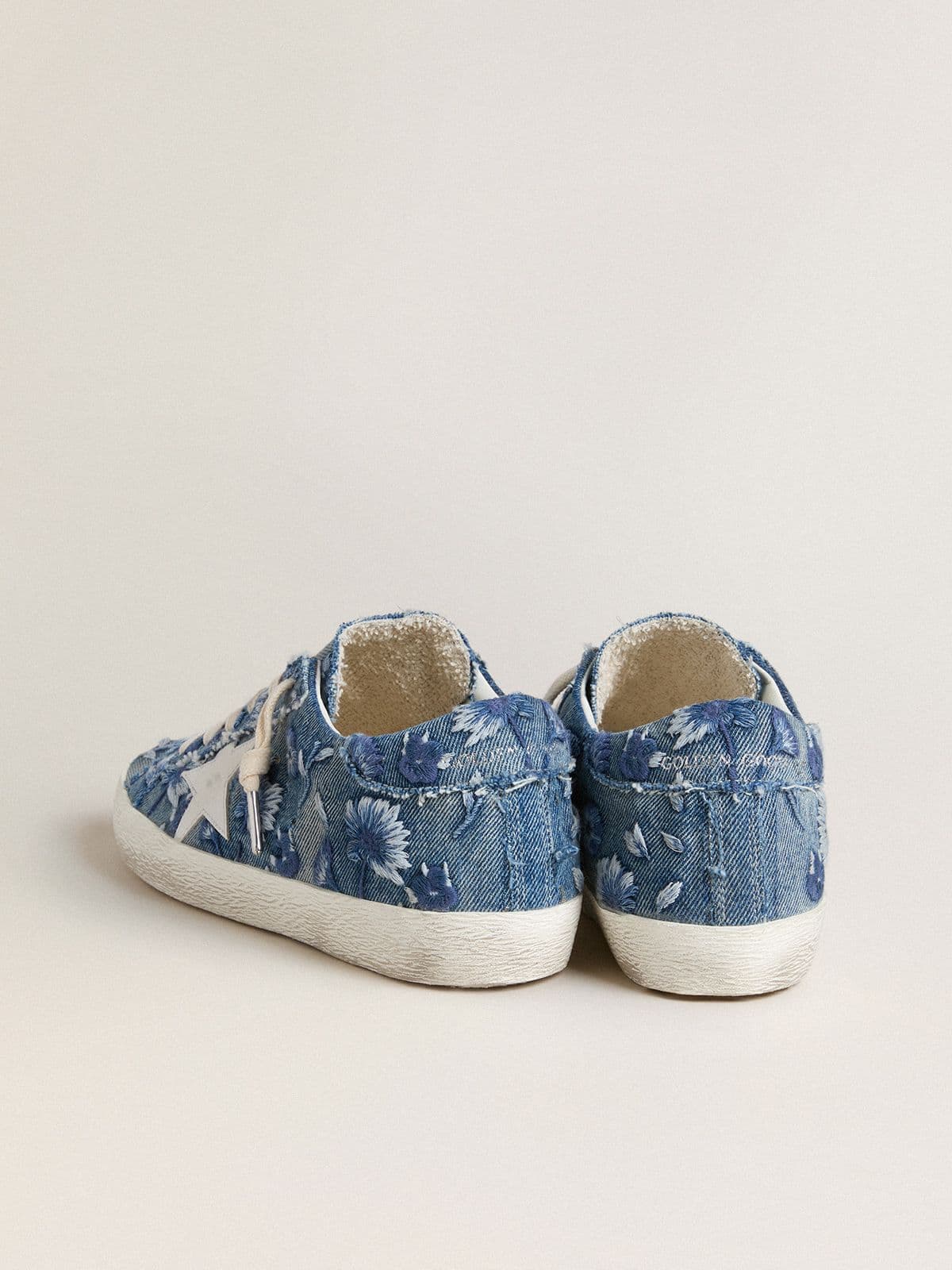 Women's Super-Star LTD in light blue denim with a white leather star and embroidered flowers