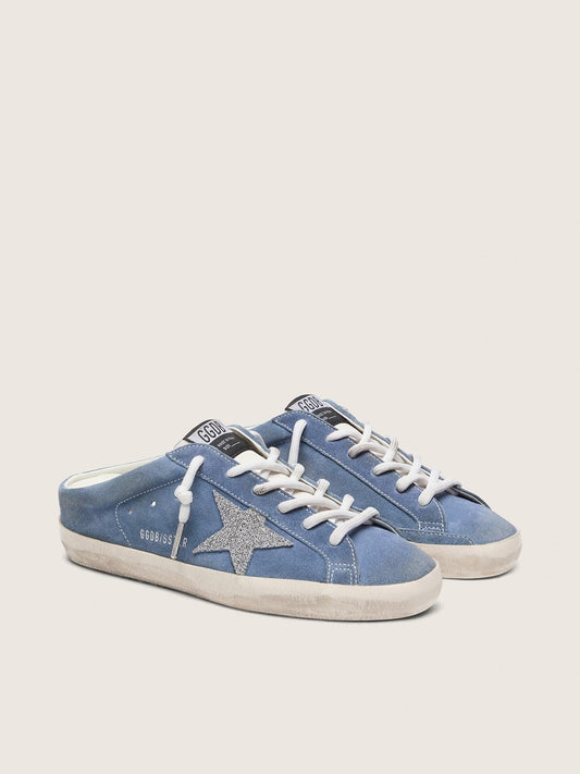 Women’s Super-Star Sabots in denim-blue suede with silver glitter star