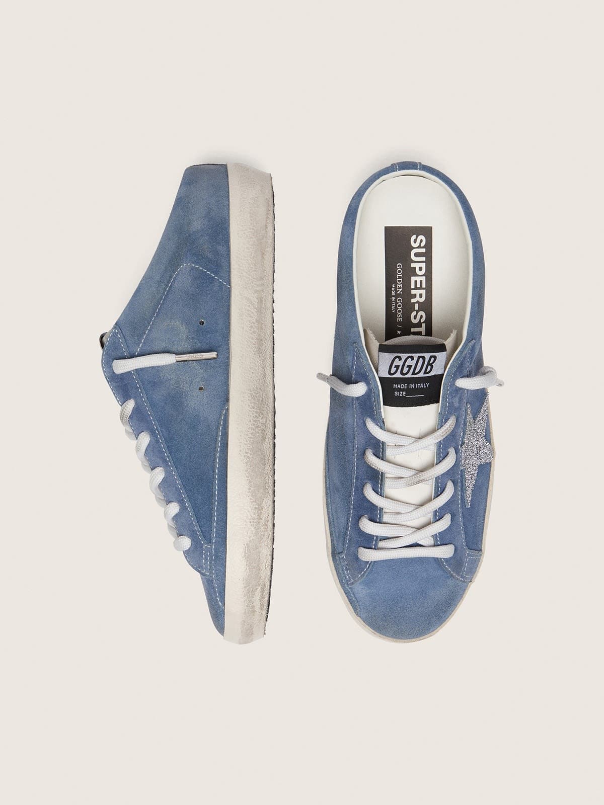 Women’s Super-Star Sabots in denim-blue suede with silver glitter star