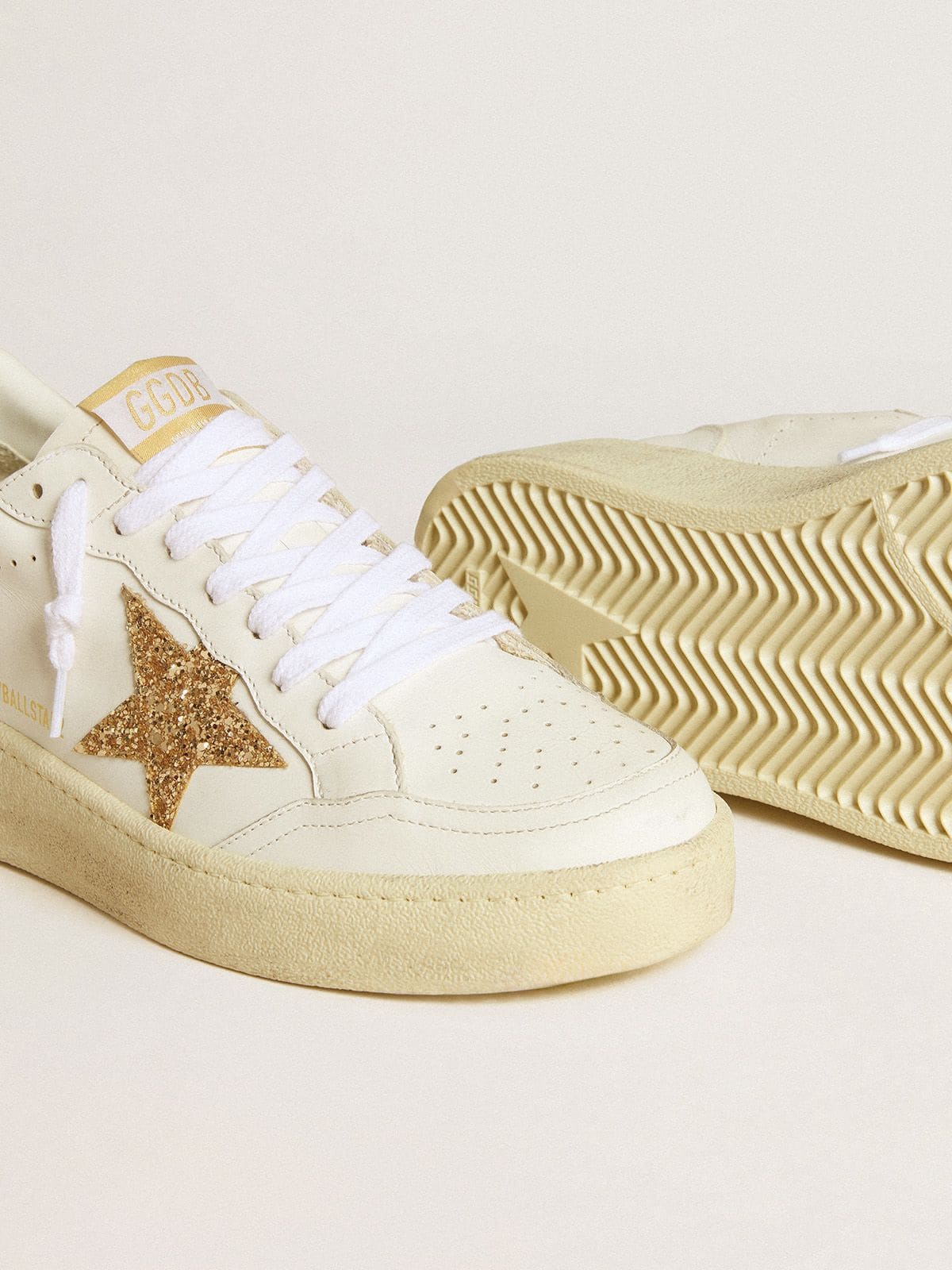 Women’s Ball Star in white leather with gold glitter star and black glitter heel tab