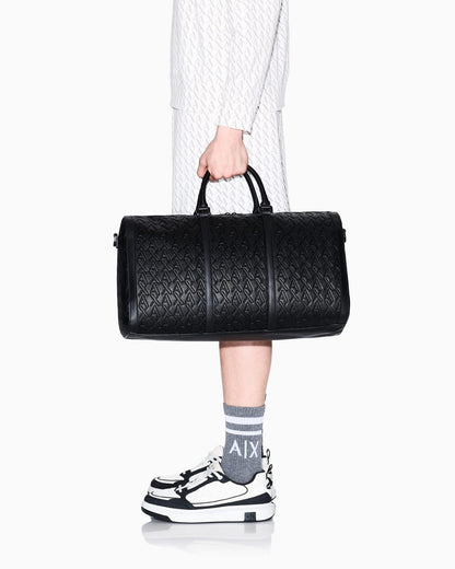 Duffel bag with an embossed pattern and a shoulder strap
