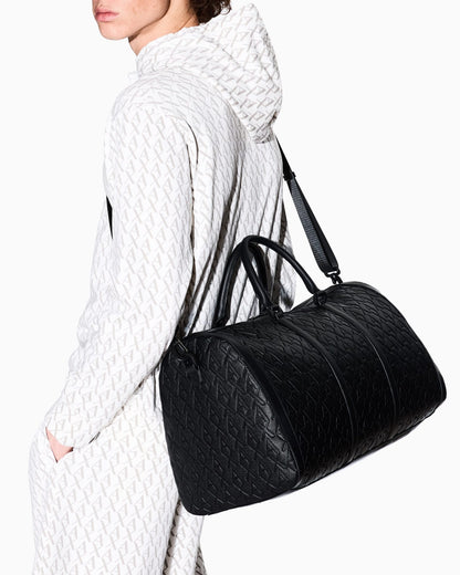 Duffel bag with an embossed pattern and a shoulder strap