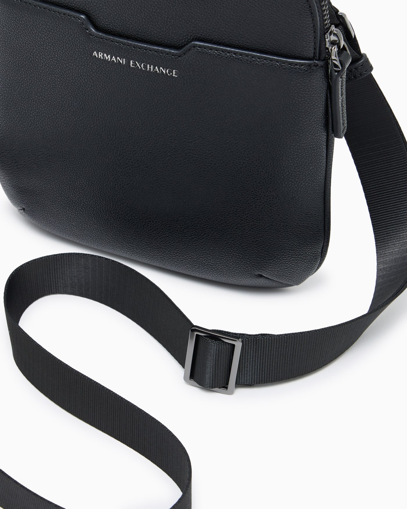 Textured crossbody bag with a zipper and adjustable strap