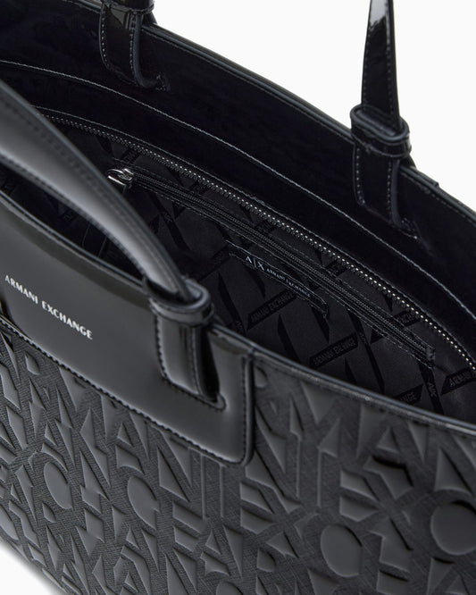 Tote bag with an embossed pattern and a metallic charm