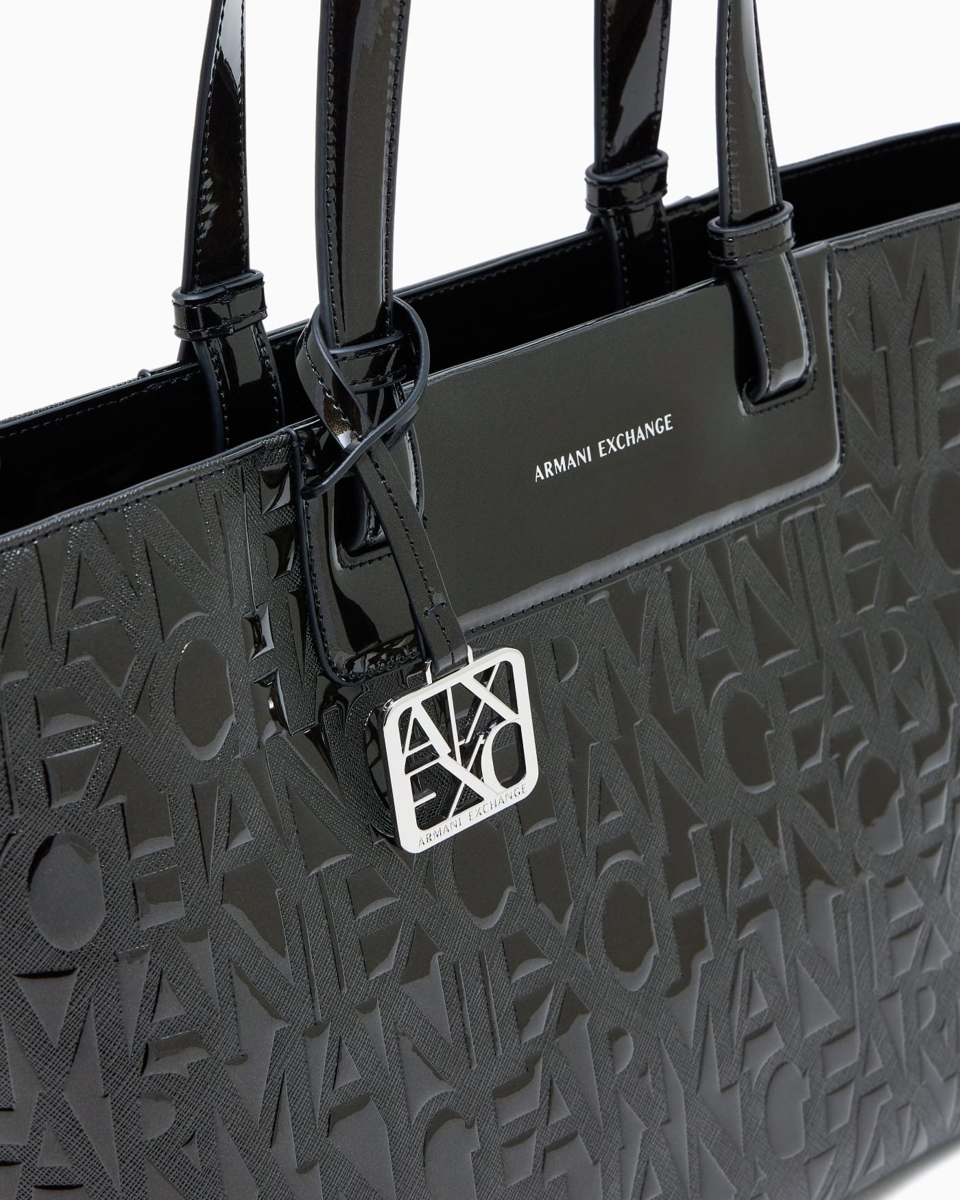 Tote bag with an embossed pattern and a metallic charm