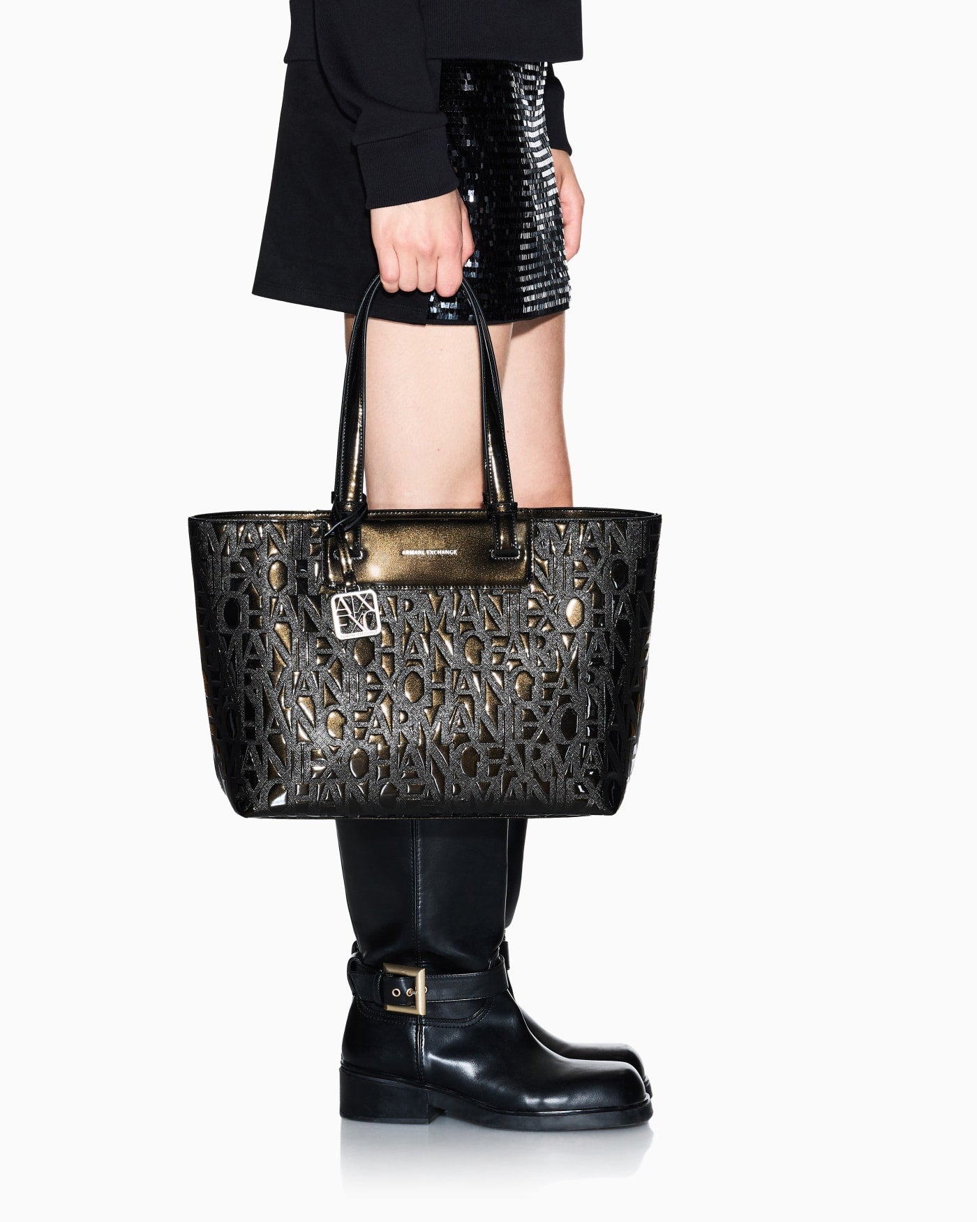 Tote bag with an embossed pattern and a metallic charm