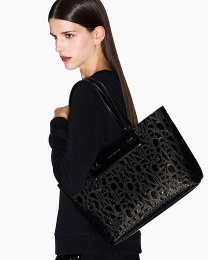 Tote bag with an embossed pattern and a metallic charm